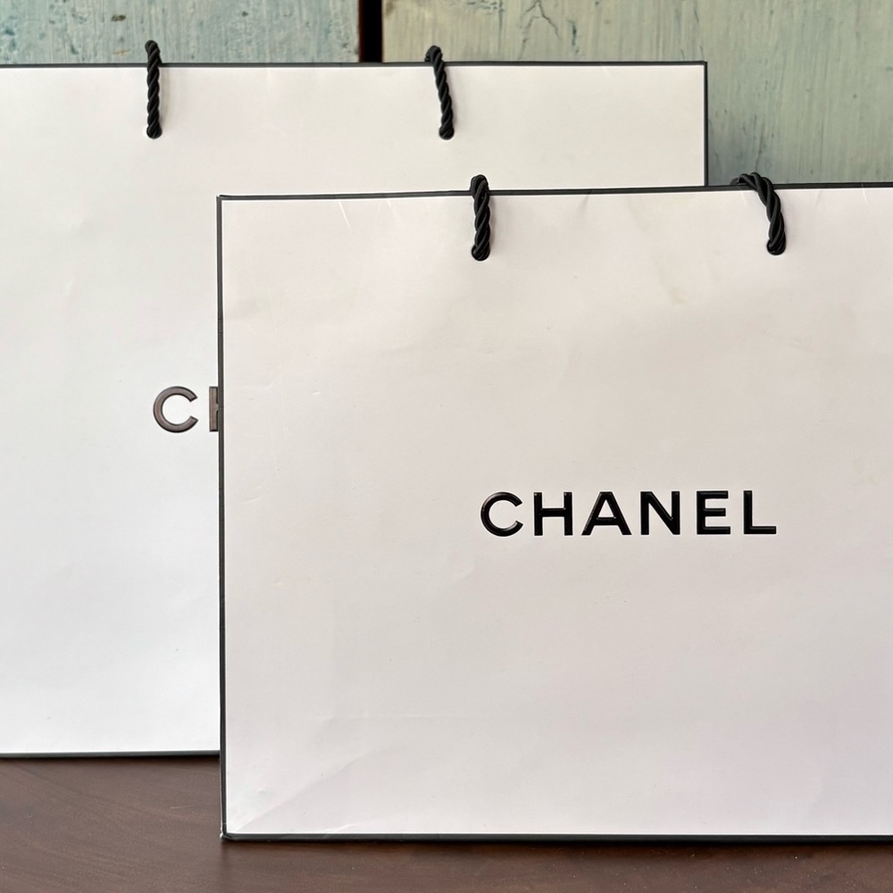 Two sizes CHANEL tote type shopping bags: 11-1/2” x 9-3/4” x 5,” & 10” x 8” x 3”